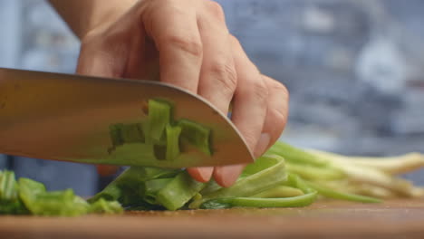 To-cut-green-onions.-The-cuts-green-onions-on-a-wooden-board.-Healthy-food